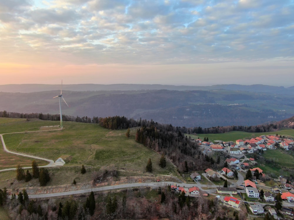 a wind turbine on top of a hill