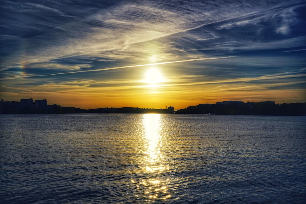 body of water during sunset