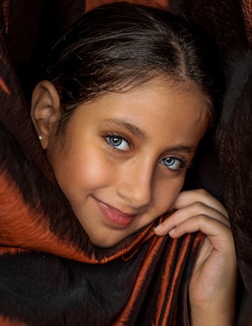 woman in black and orange scarf