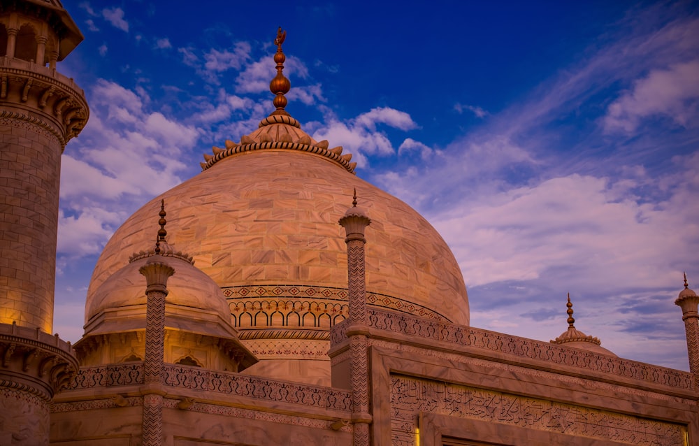 brown and white concrete dome building under blue sky during daytime