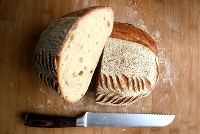 Artisan bread loaf sliced open to reveal a creamy cheese filling.