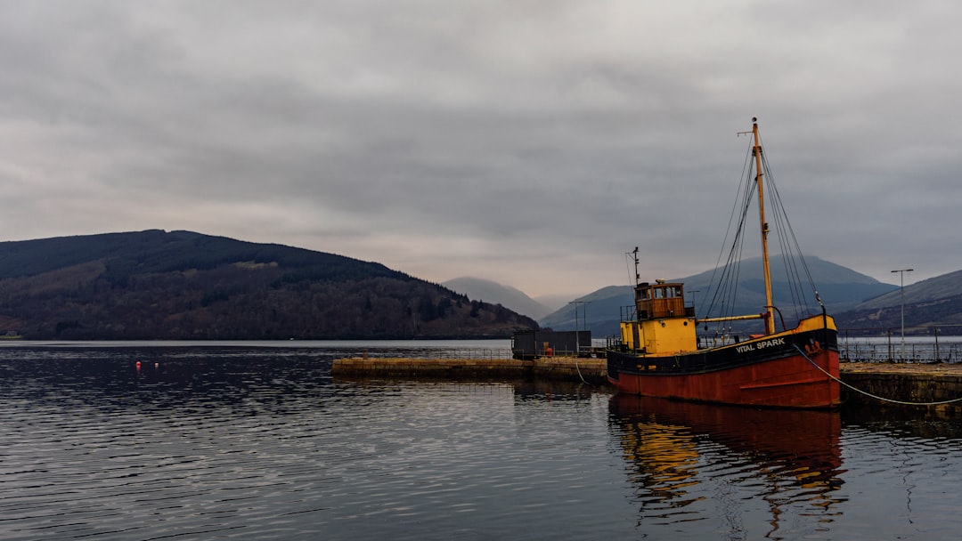 A colorful boat in a beautiful scottish loch