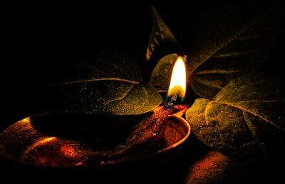 Soft glowing lamp illuminating old palm leaf manuscripts.