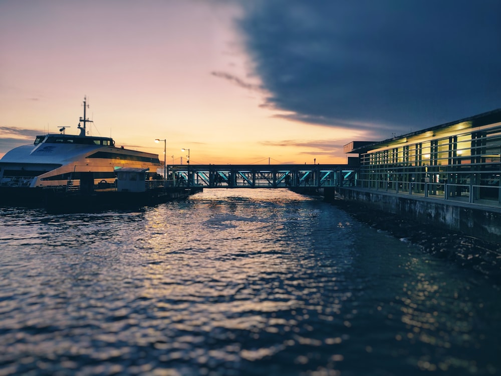 white and brown boat on dock during sunset