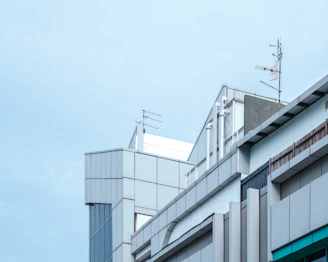A sleek modern commercial building with visible network infrastructure elements integrated seamlessly.