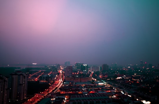 city with high rise buildings during night time in Malacca Malaysia