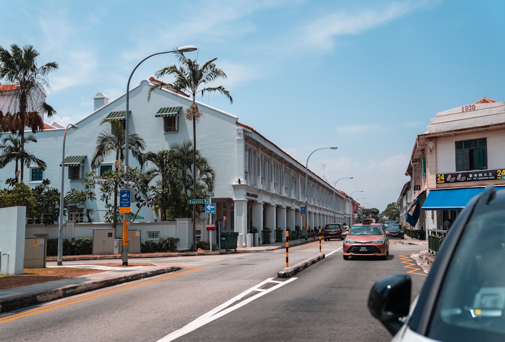 cars parked on side of road near building during daytime