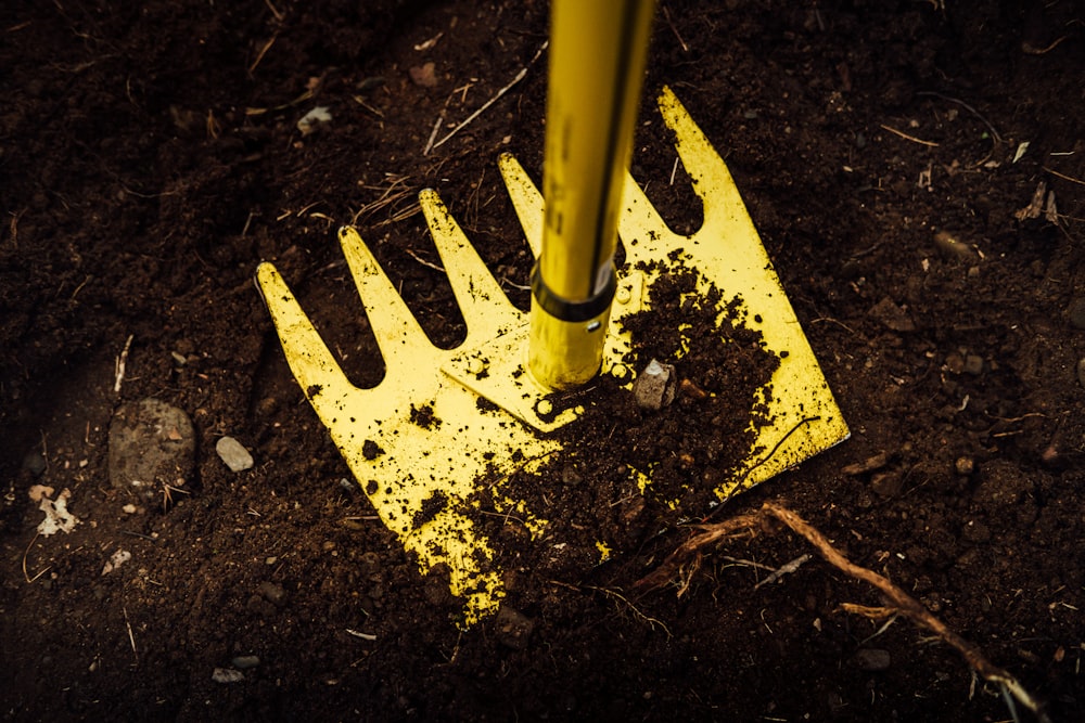 yellow metal pipe on brown soil