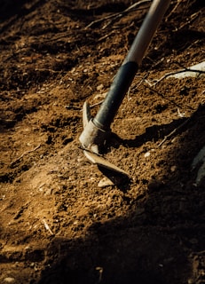 gray metal pipe on brown soil