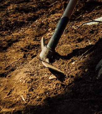 gray metal pipe on brown soil