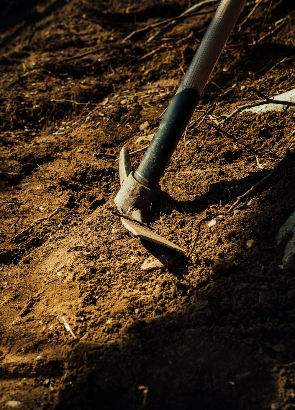 gray metal pipe on brown soil