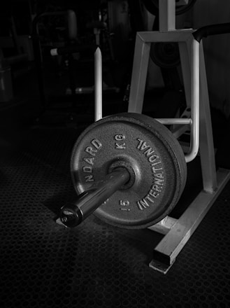 black and gray dumbbell on black textile