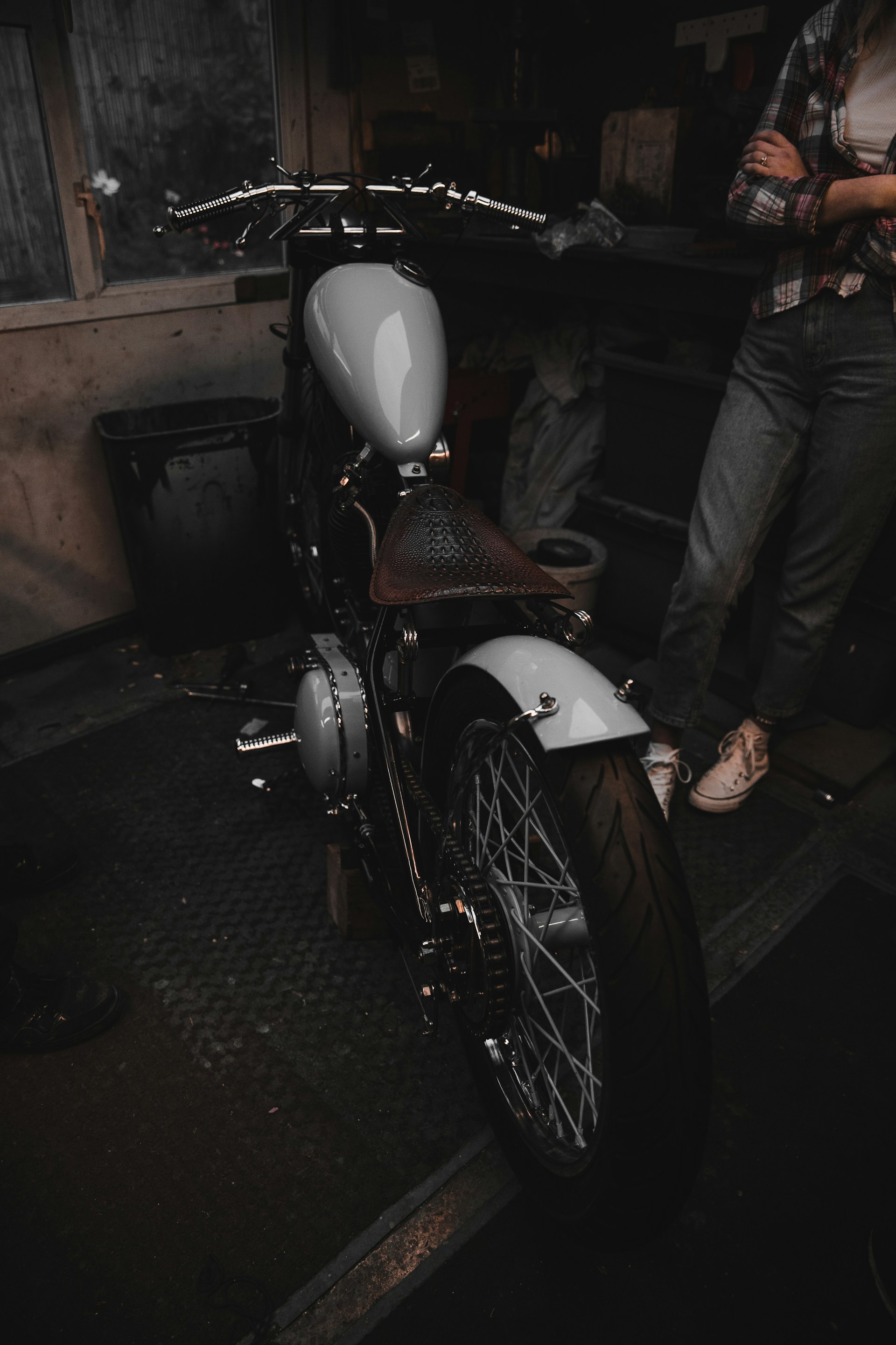 white and red motorcycle near man in black pants