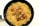 A black frying pan contains a serving of cooked pasta and noodles mixed with vegetables such as broccoli and bell peppers. Three grilled chicken drumsticks are placed on top of the pasta, creating a visually appealing dish.