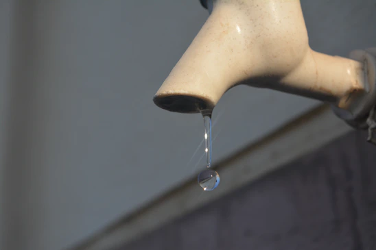 Close-up of a precision-engineered water-saving device installed on an industrial faucet.