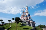 white and blue castle under white clouds and blue sky during daytime