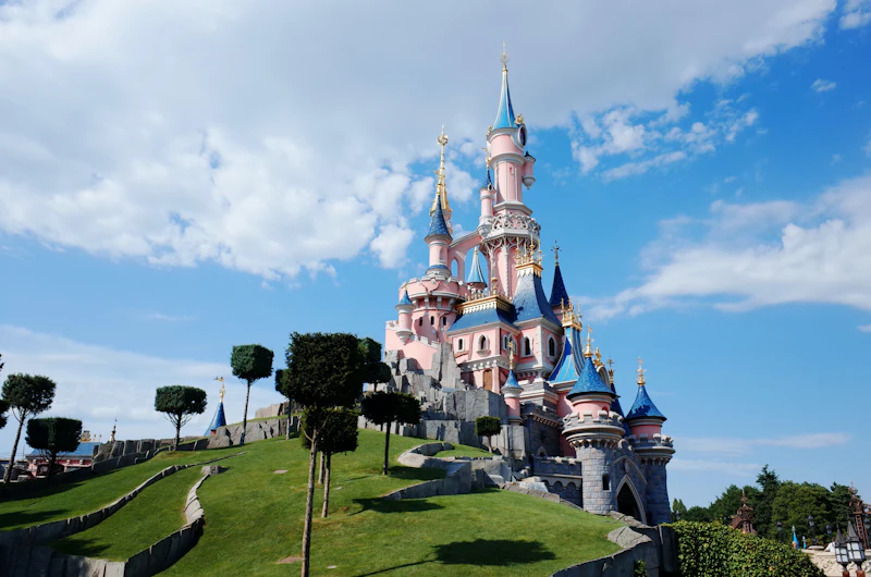 Sleeping Beauty Castle at Disneyland Paris under a blue sky