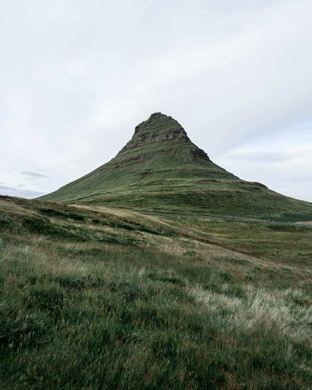 green mountain under white clouds during daytime