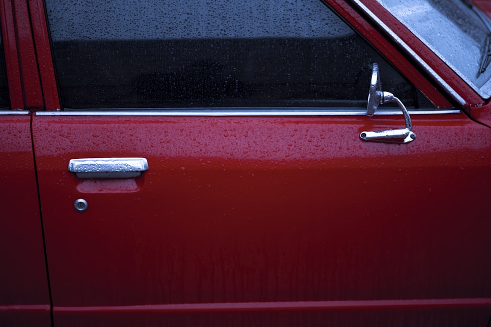 red car with silver door lever