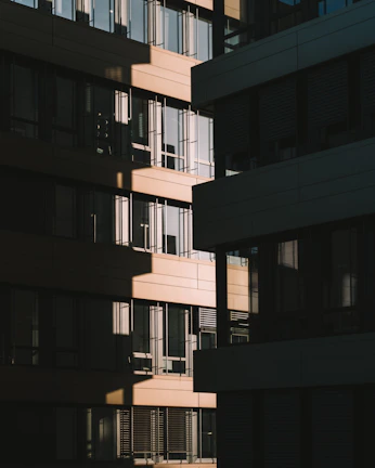 An exterior façade clad in textured granite, highlighting architectural lines under daylight.