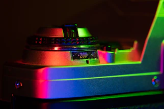 A cinematic shot of a vintage film camera beside a glowing red record button.
