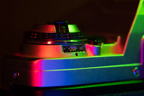A cinematic shot of a vintage film camera beside a glowing red record button.