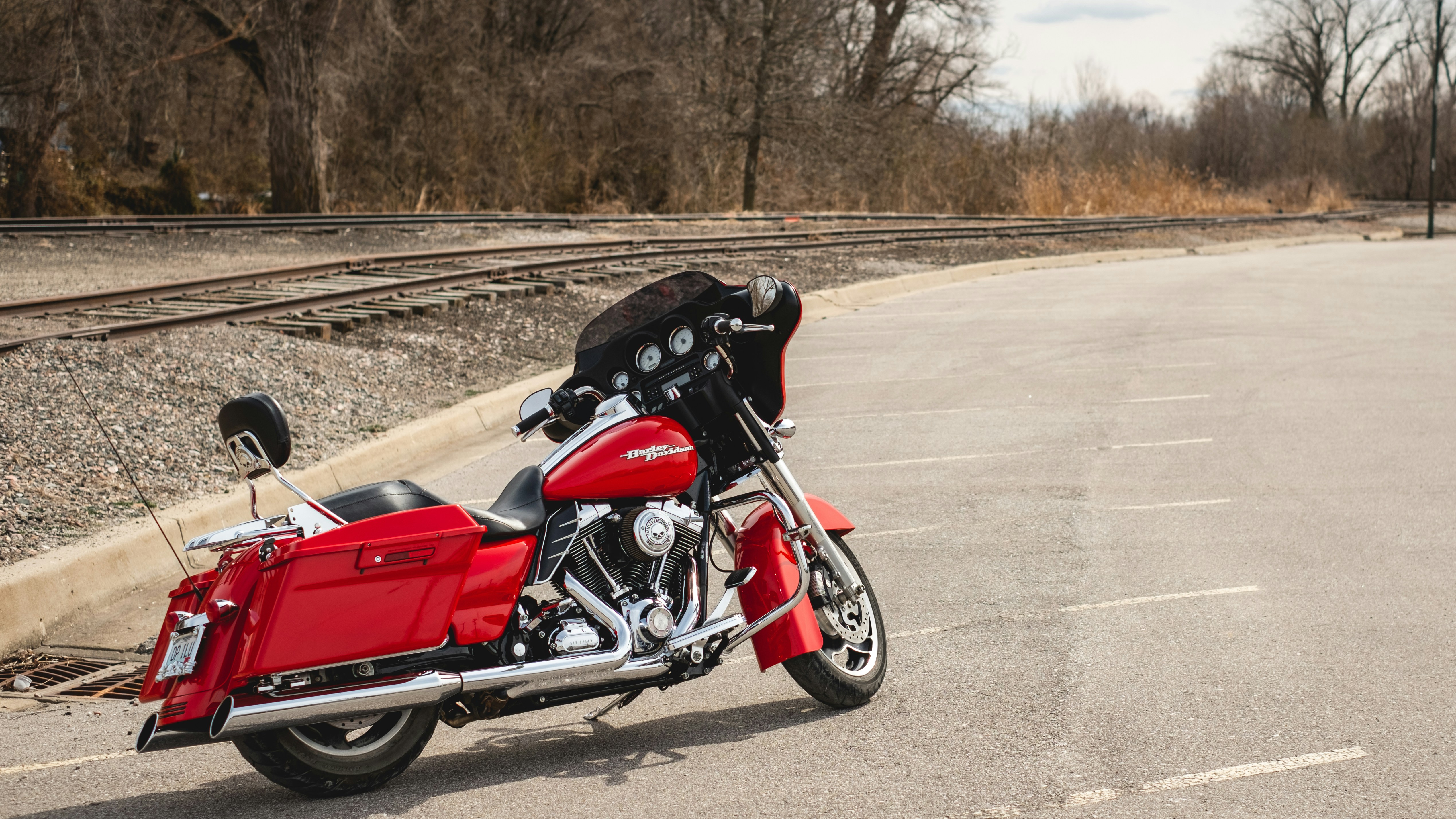 red and black cruiser motorcycle on road during daytime