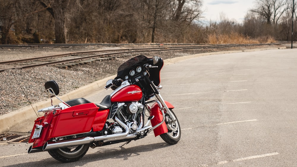 red and black cruiser motorcycle on road during daytime