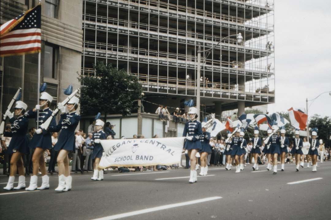 people in white and blue shirts running on road during daytime