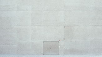 Wide shot of concrete wall with cleanly cut door opening.