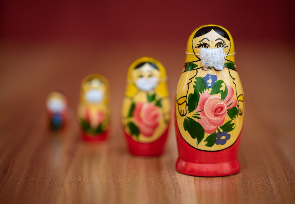 two yellow and red ceramic owl figurines