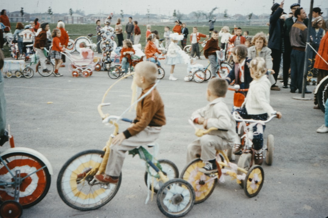 people riding on bicycle on road during daytime