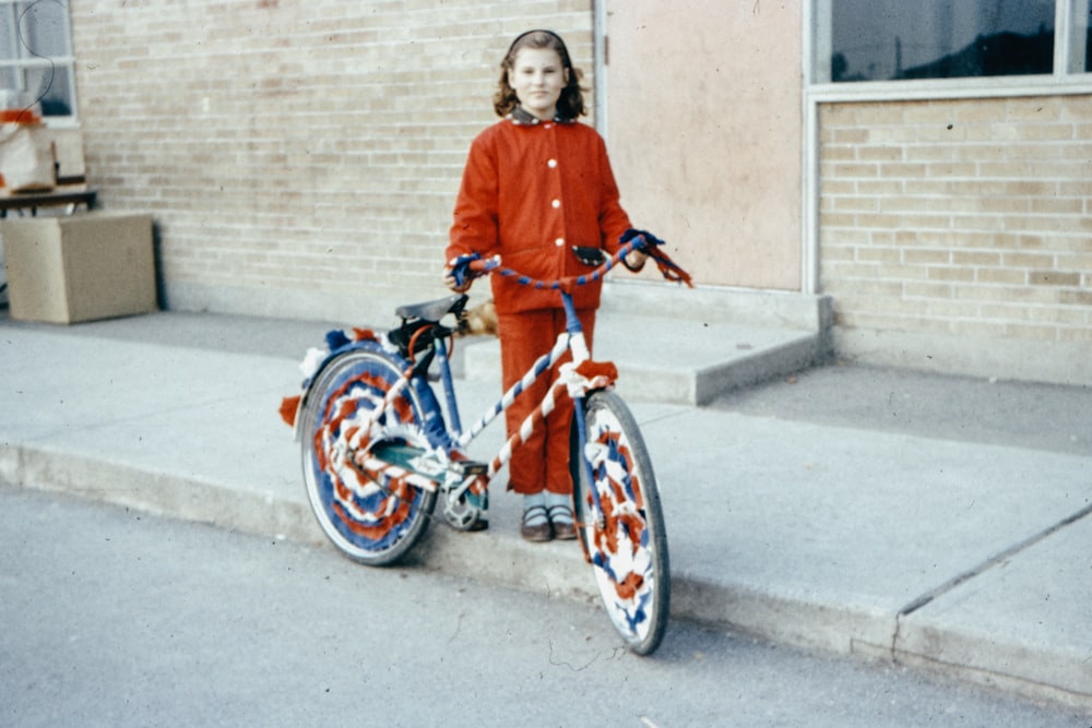 woman in blue long sleeve shirt riding on red bicycle