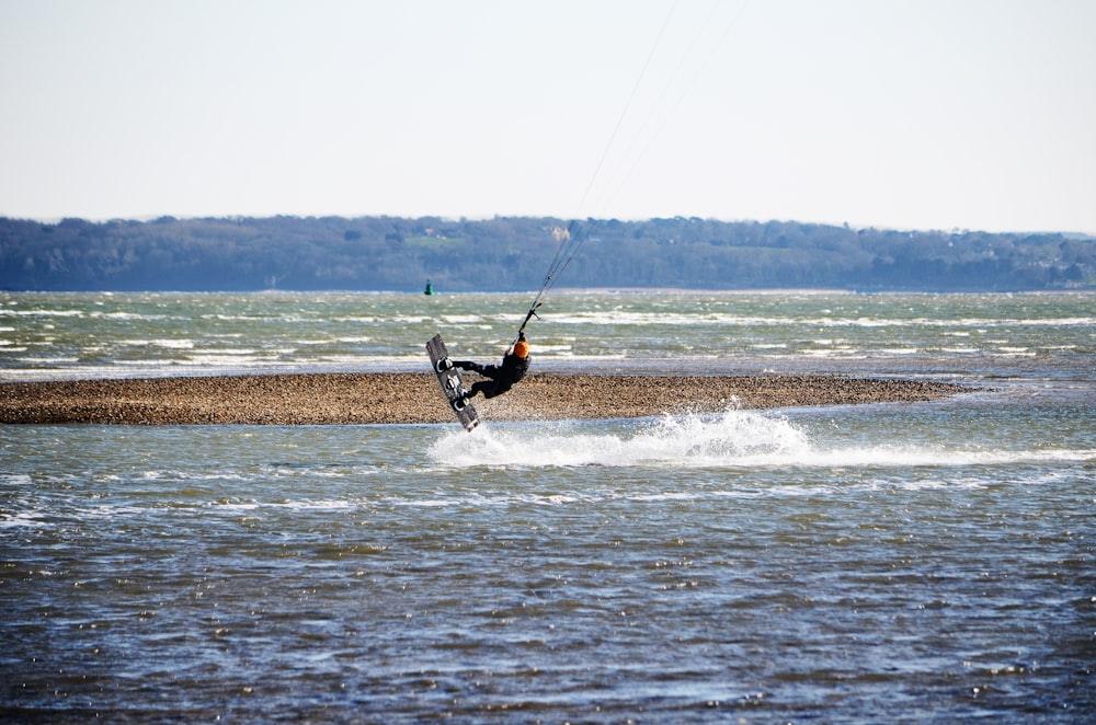 man surfing on sea during daytime