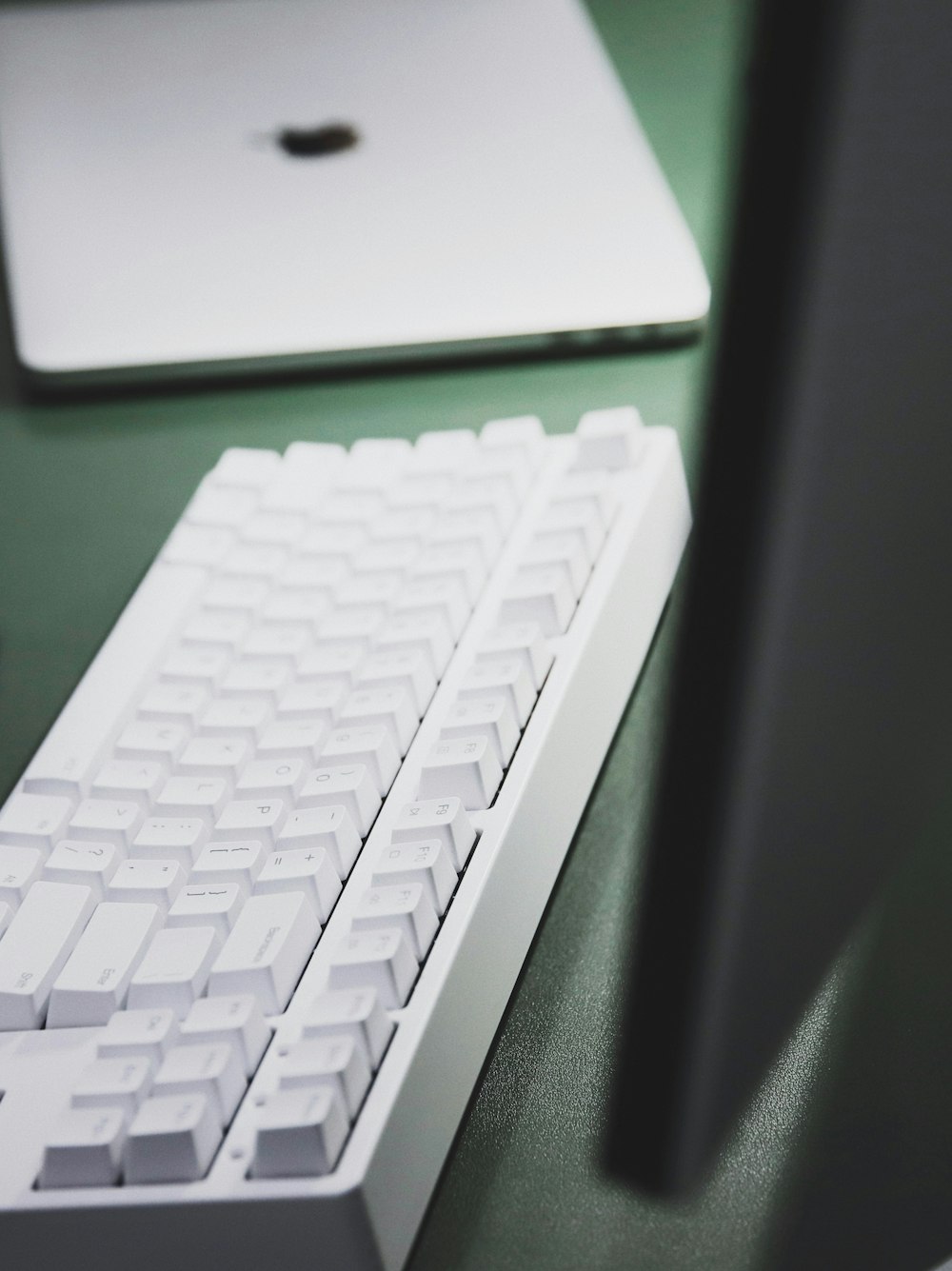 white computer keyboard on black table