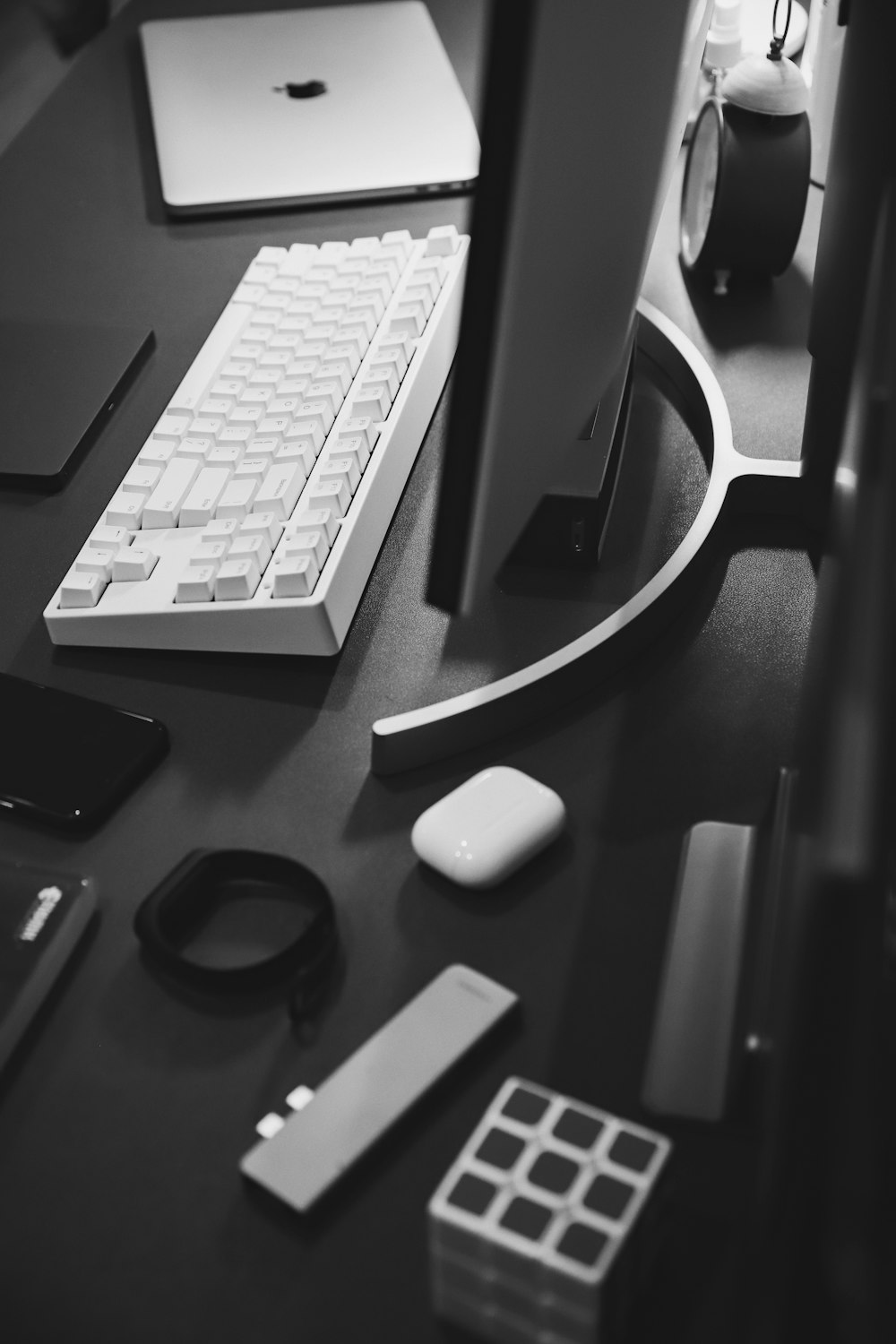 apple keyboard and black smartphone on table