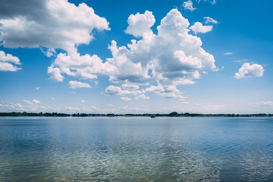 blue sea under blue sky and white clouds during daytime