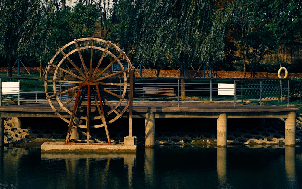brown wooden wheel on brown wooden dock during daytime