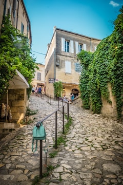 woman in green coat walking on pathway during daytime