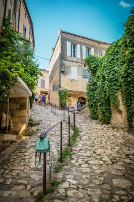 woman in green coat walking on pathway during daytime