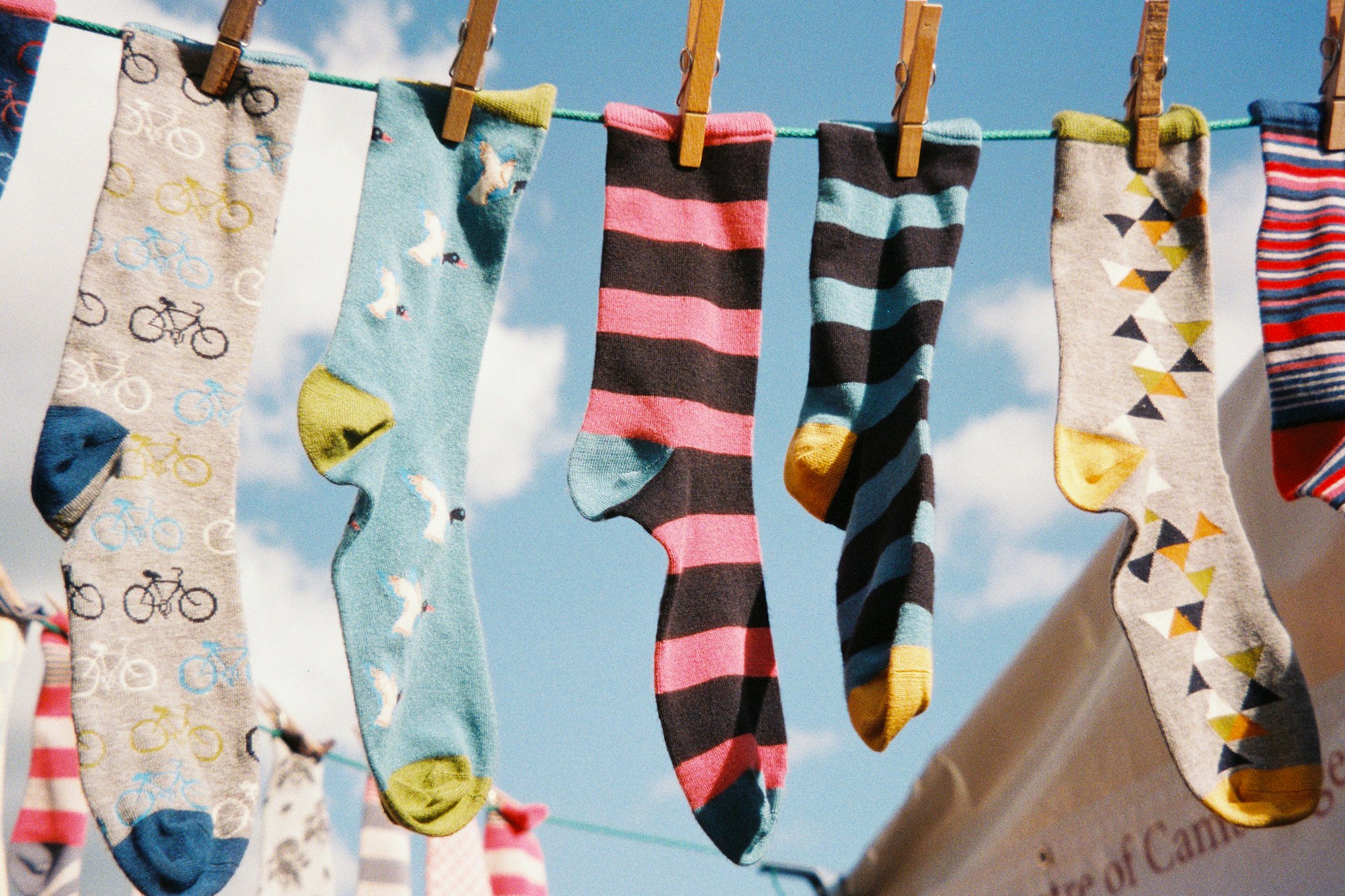 A row of different socks pegged on a line. Shot on film.