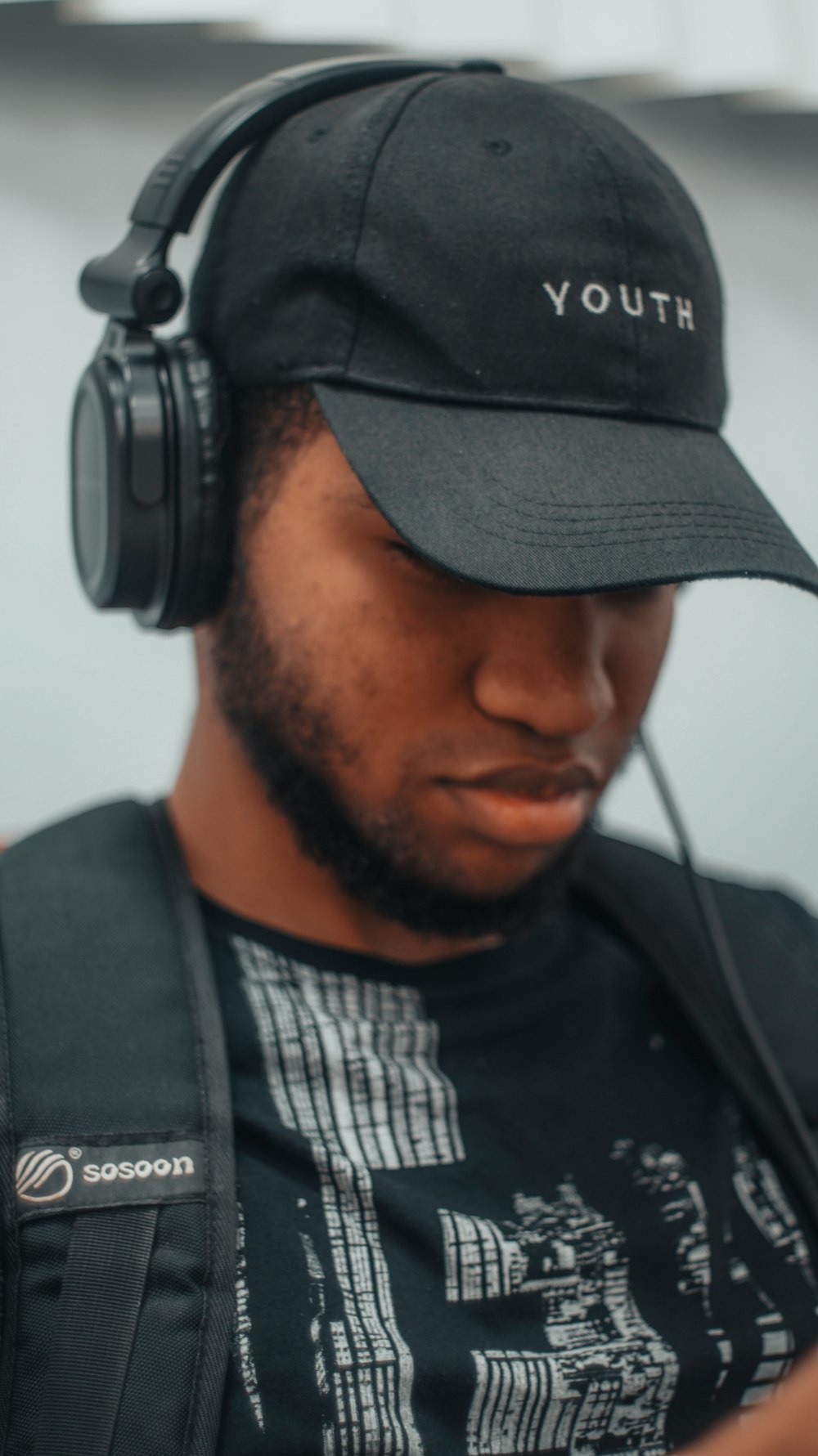 man in black crew neck shirt wearing black headphones