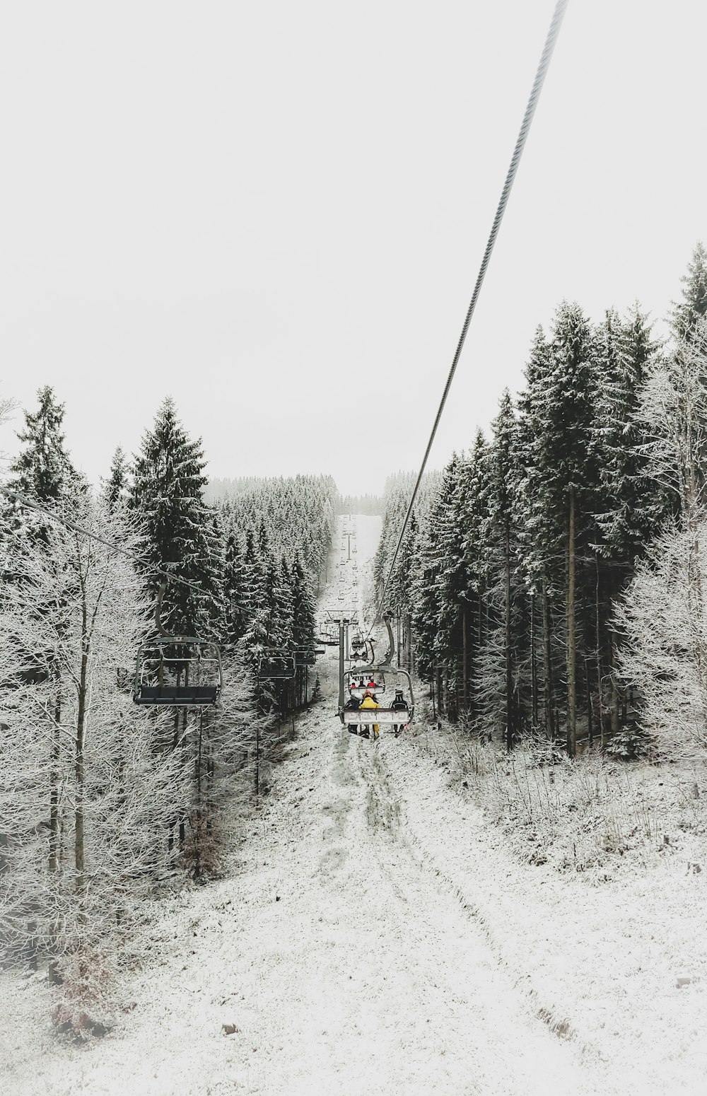 red and white cable car on snow covered ground