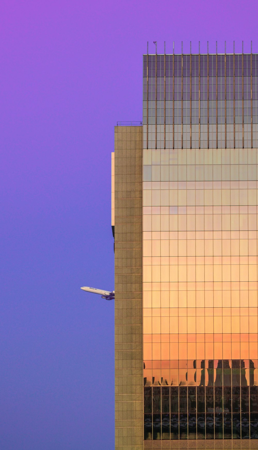 white airplane flying over brown building during daytime