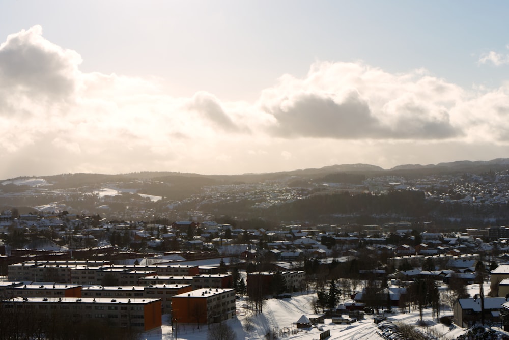 city with high rise buildings under white clouds during daytime