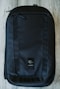 black and blue backpack on white textile