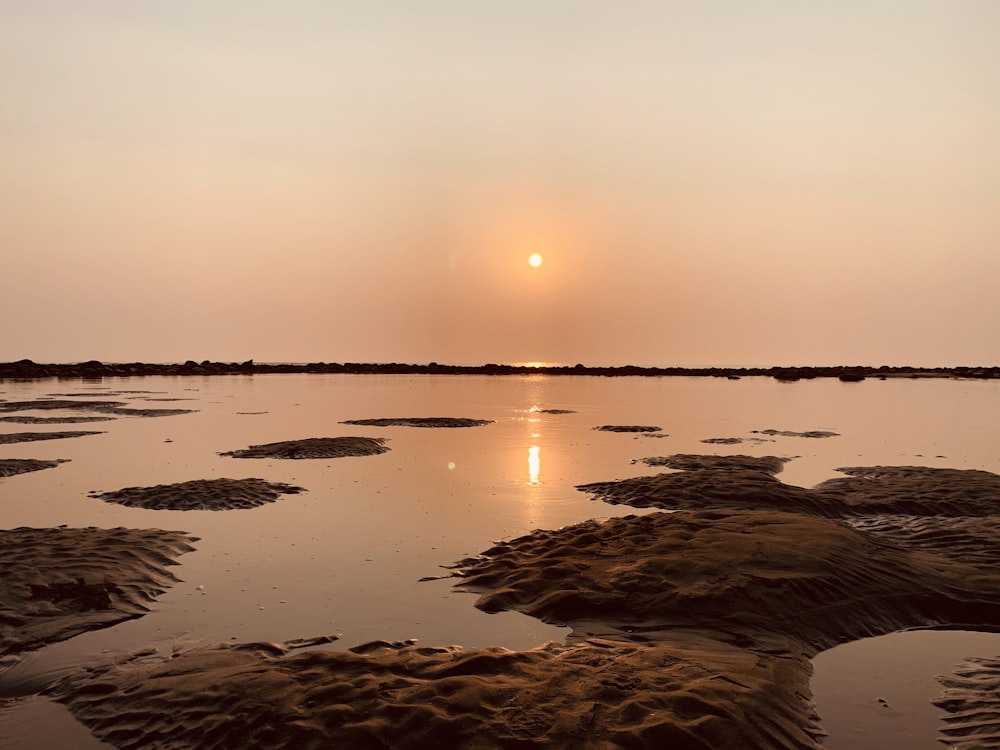 body of water during sunset