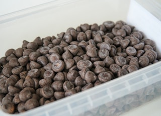 brown coffee beans on white plastic container