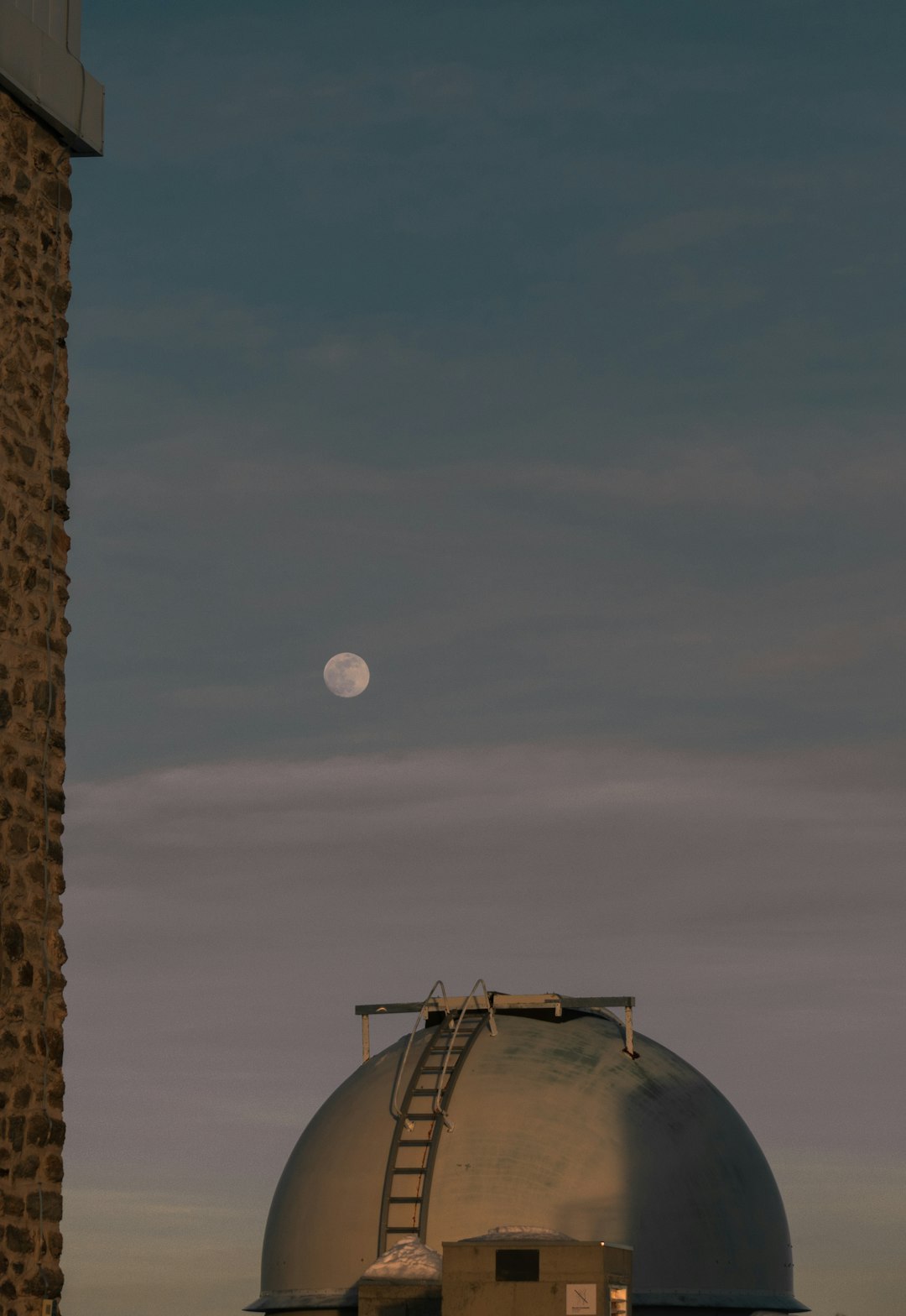full moon over brown concrete building