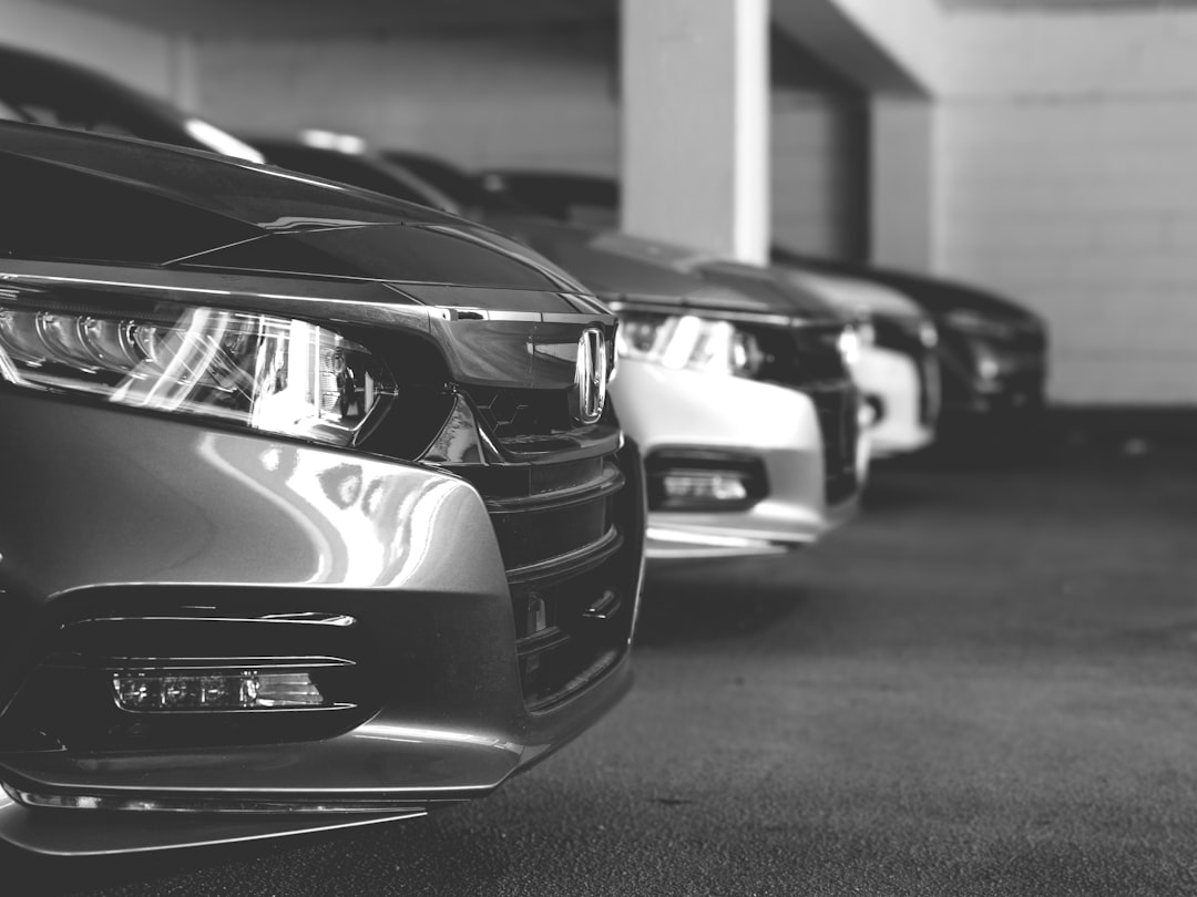 Black and white photo of a row of Honda Accords at a dealership in Fairfax Virginia with emphasis on the headlights. 